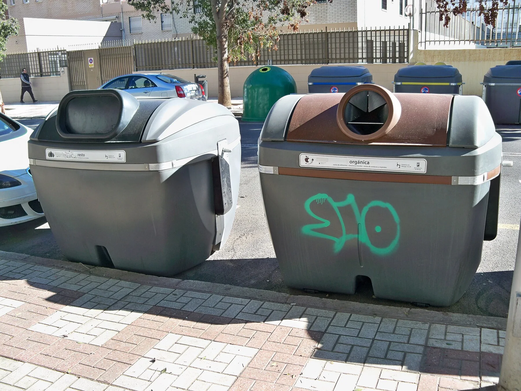 Outdoor containers are marked for non-recyclable and organic waste.