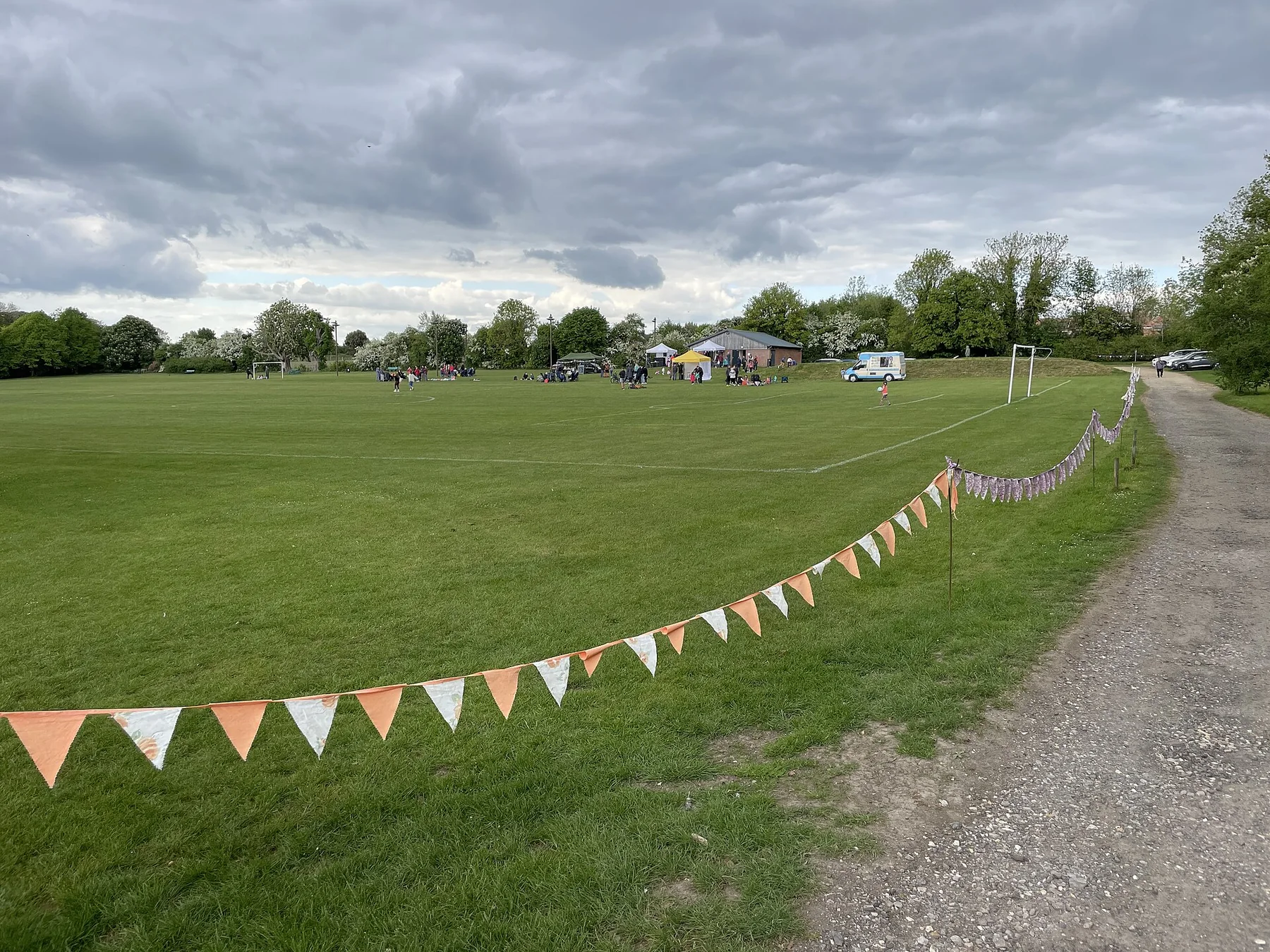 An open community field is set up for an outdoor event.